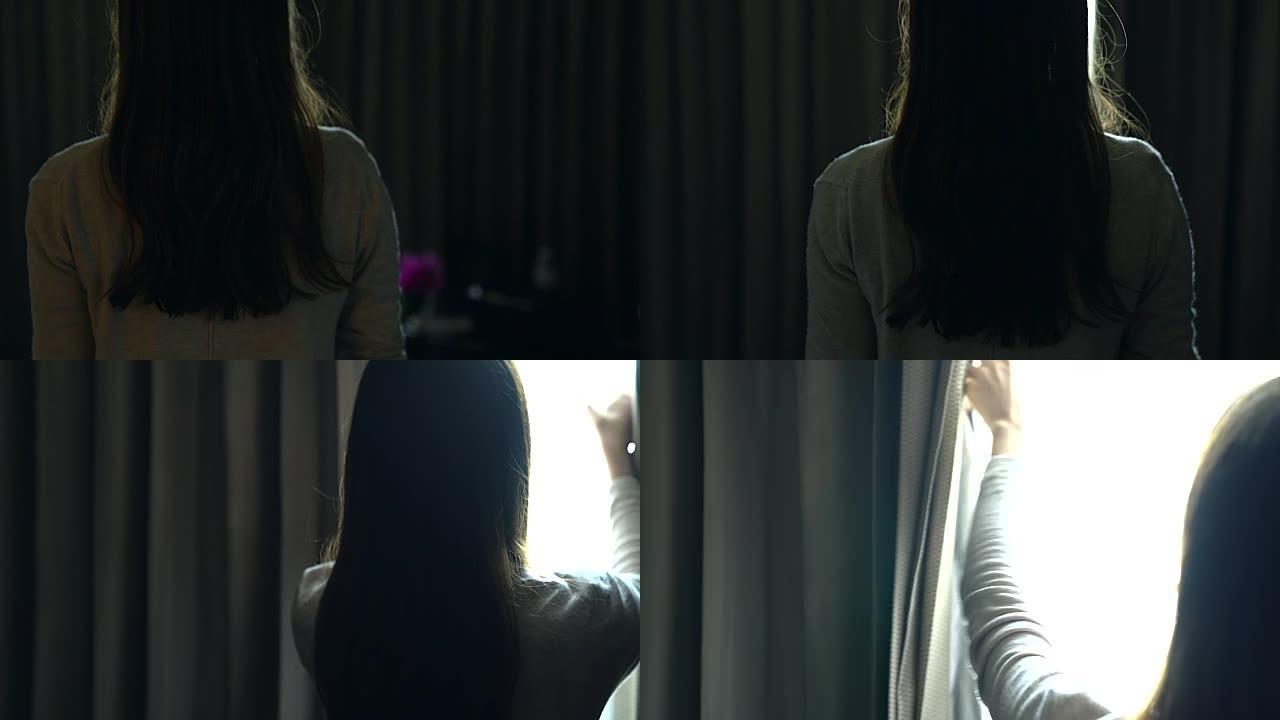 通过酒店房间或房屋的窗户向外看的体贴迷人女性的侧视图