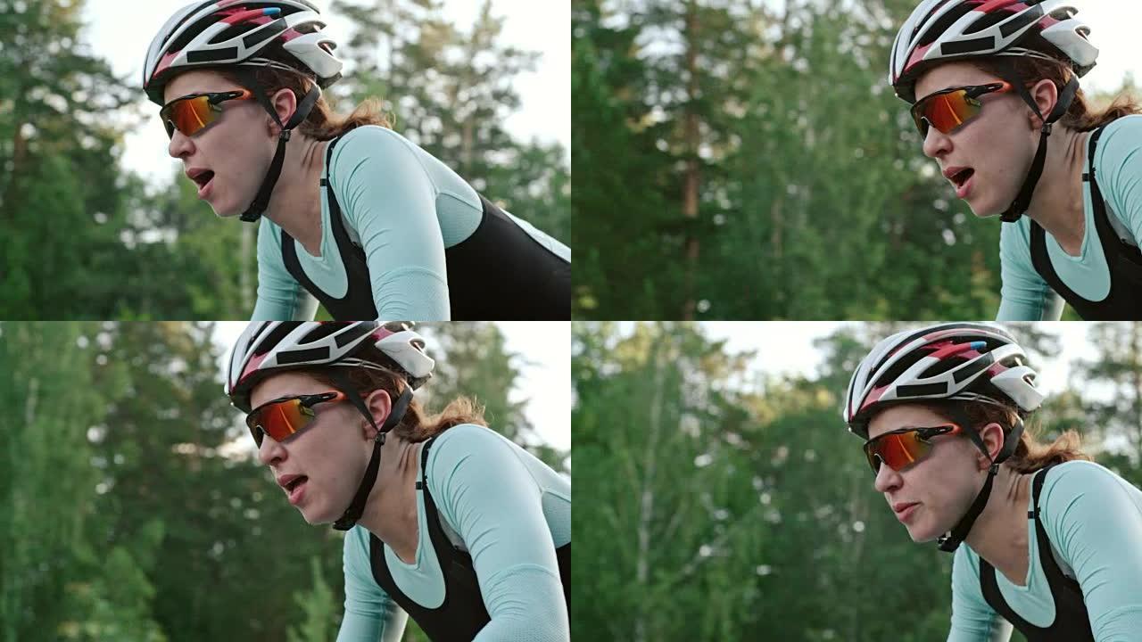 女骑自行车者骑行和呼吸困难