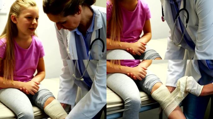 女医生在女孩受伤的腿上绑上绷带