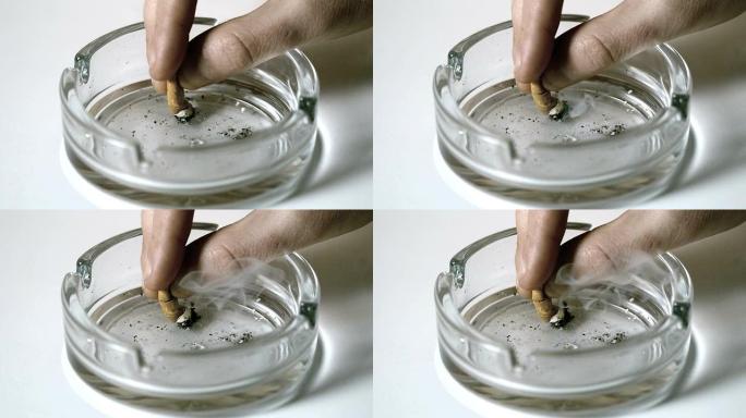 空烟灰缸中的手熄灭香烟