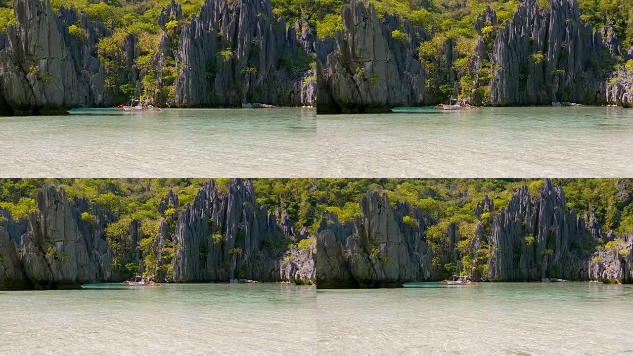 风景与菲利皮诺船，岩石和蓝湾。菲律宾巴拉望岛爱妮岛