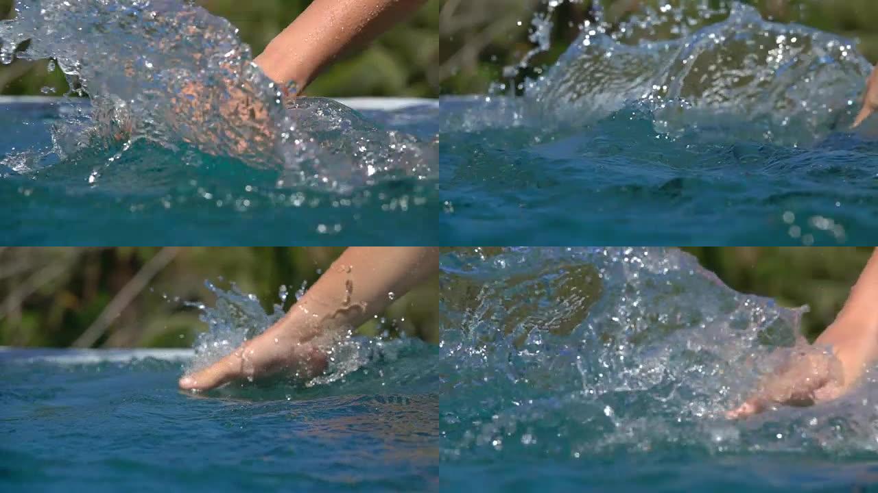 慢动作: 手拖动的细节在无边泳池中滑过水面