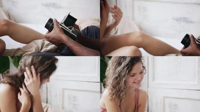 摄影师在旧的移动胶片相机上拍照的特写视图。穿着睡衣的年轻女子对男人摆姿势