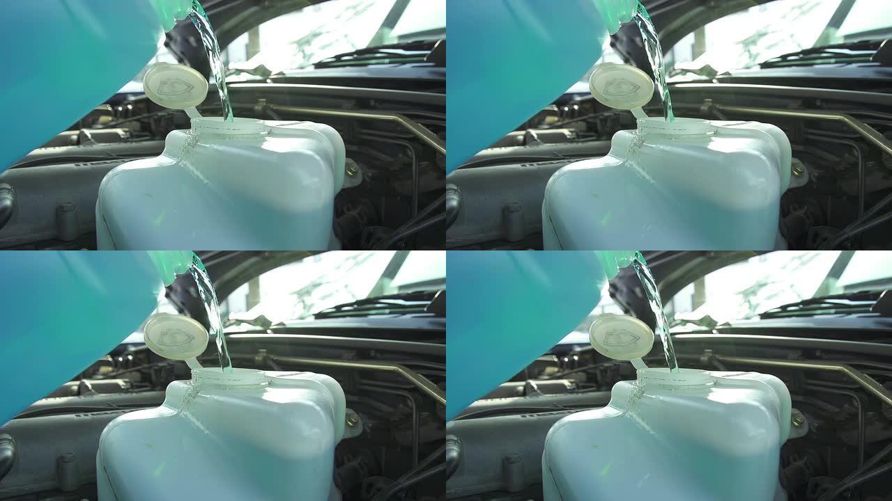 慢动作: 将挡风玻璃液体倒入汽车