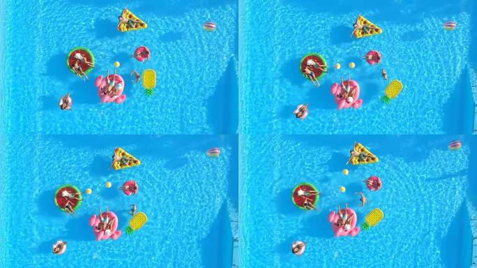 空中快乐的年轻朋友在游泳池里有趣的彩色漂浮物上玩球