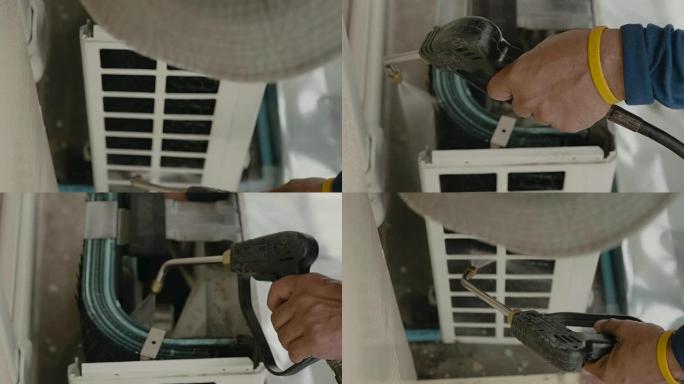 一名工人修理空调