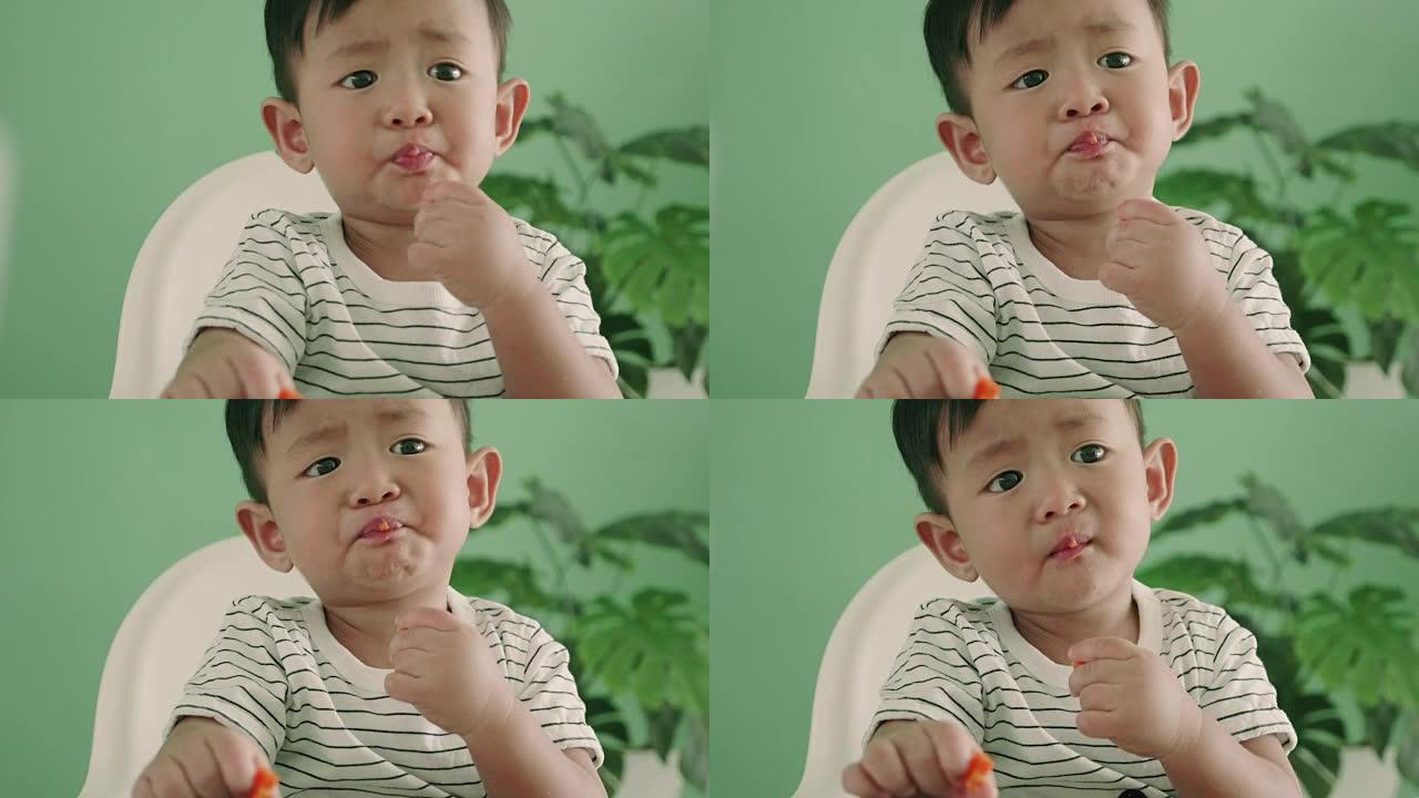 亚洲男婴吃胡萝卜，特写