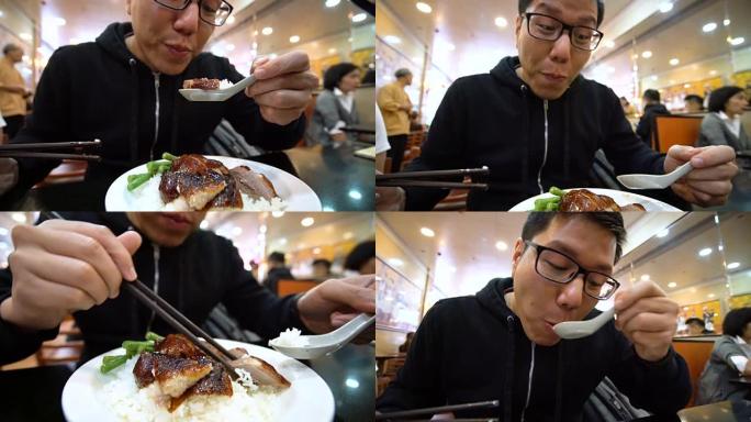 亚洲男子在当地餐馆吃烤鹅