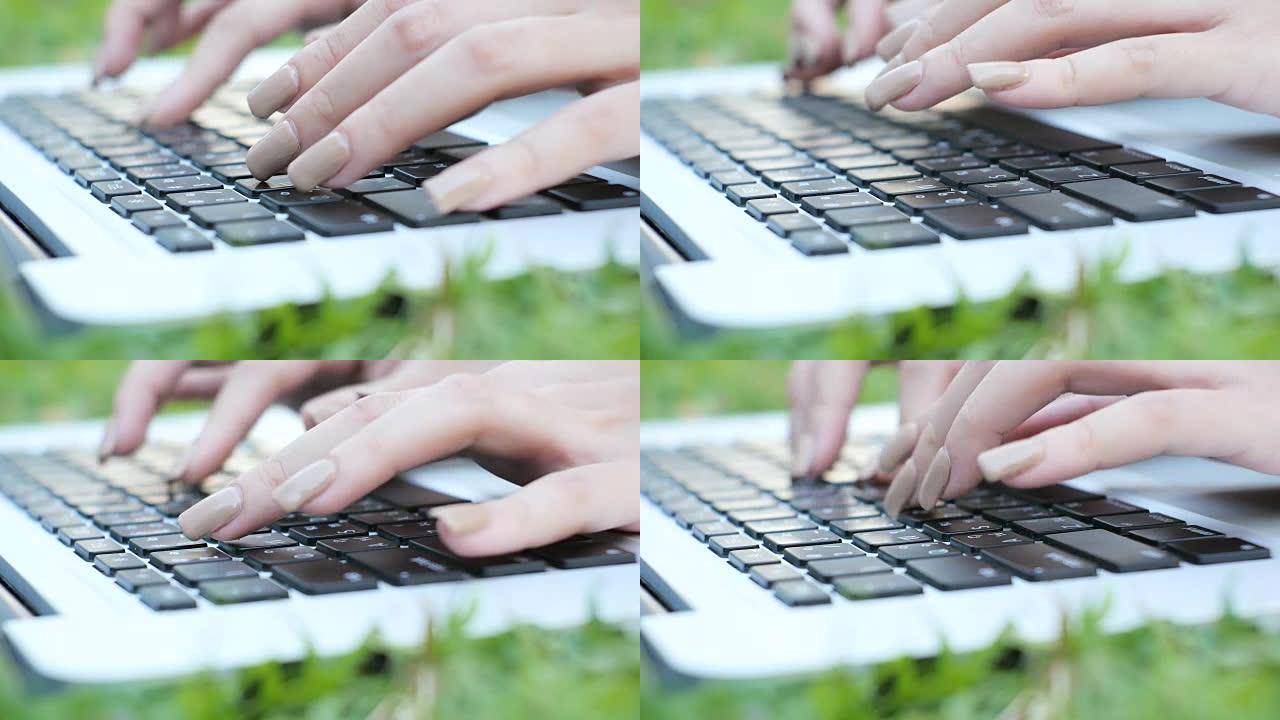 年轻的亚洲妇女的腿在绿色的草地上打开笔记本电脑。女孩的手放在键盘上。远程学习概念。快乐的潮人年轻的亚