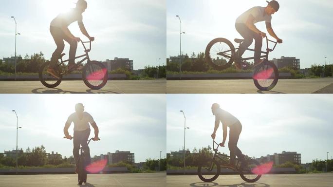 慢动作: 极端的bmx骑自行车的人在日落时在城市做很酷的尾巴鞭打技巧