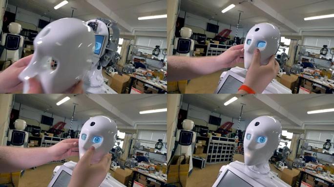 一名男子将机器人可怕的头藏在白色面具下。