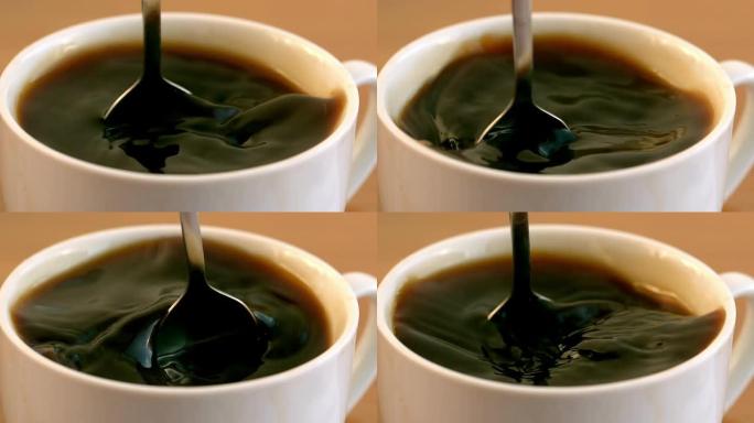 茶匙在杯子里搅拌咖啡