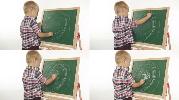 男孩在黑板上画画男孩在黑板上画画