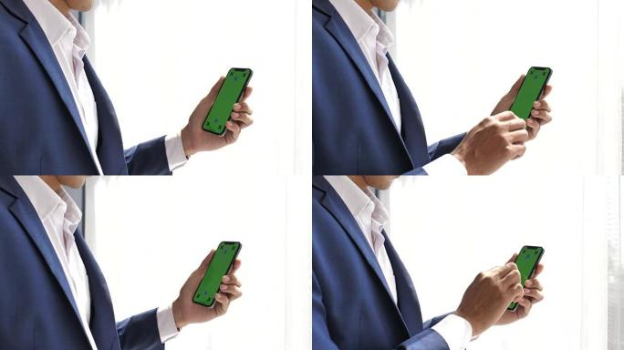 商人使用带有绿屏的智能手机