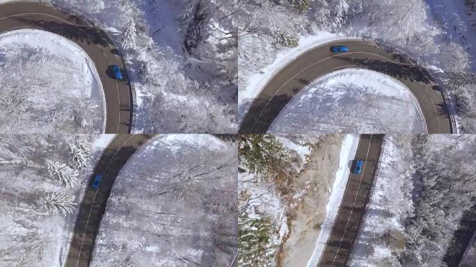 空中: 蓝色车辆在白雪皑皑的冬季仙境中行驶急转弯
