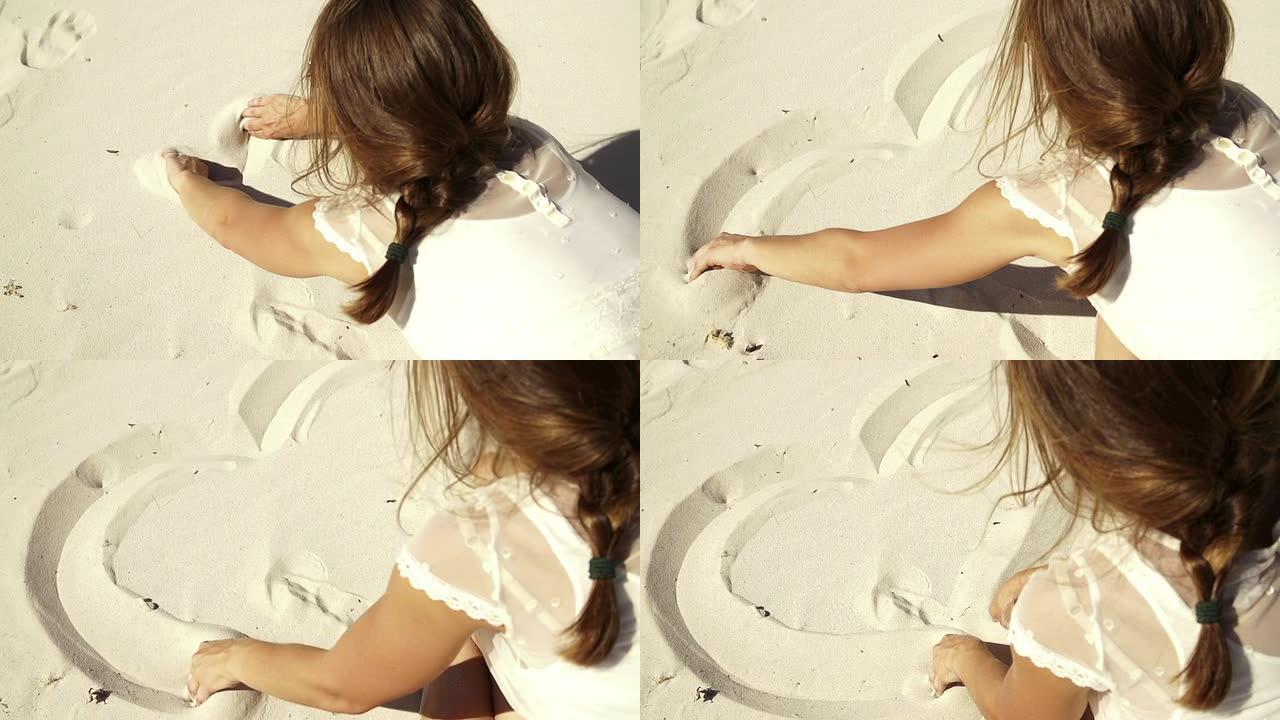 女孩正在把一颗心画成沙子