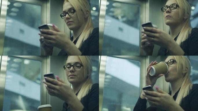 女人在电梯里喝咖啡和使用手机