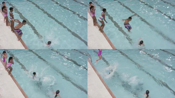多民族儿童跳进游泳池