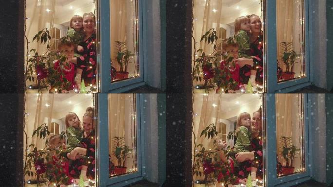 圣诞节，母亲和孩子们跑到窗户上看雪