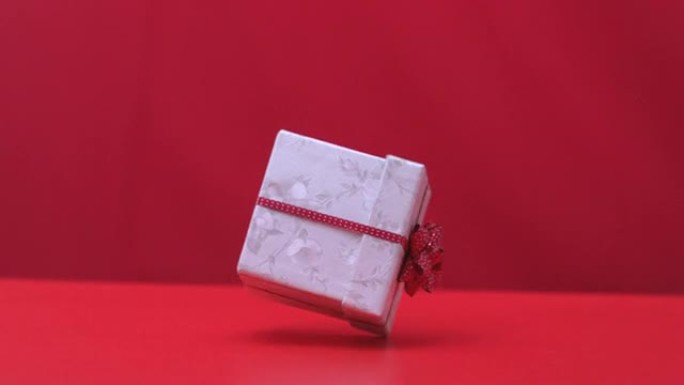 红色背景上的圣诞礼物掉落和弹跳