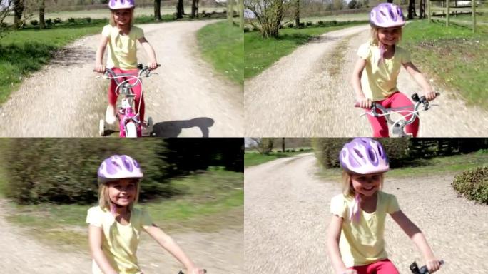 年轻女孩沿着乡村赛道骑自行车