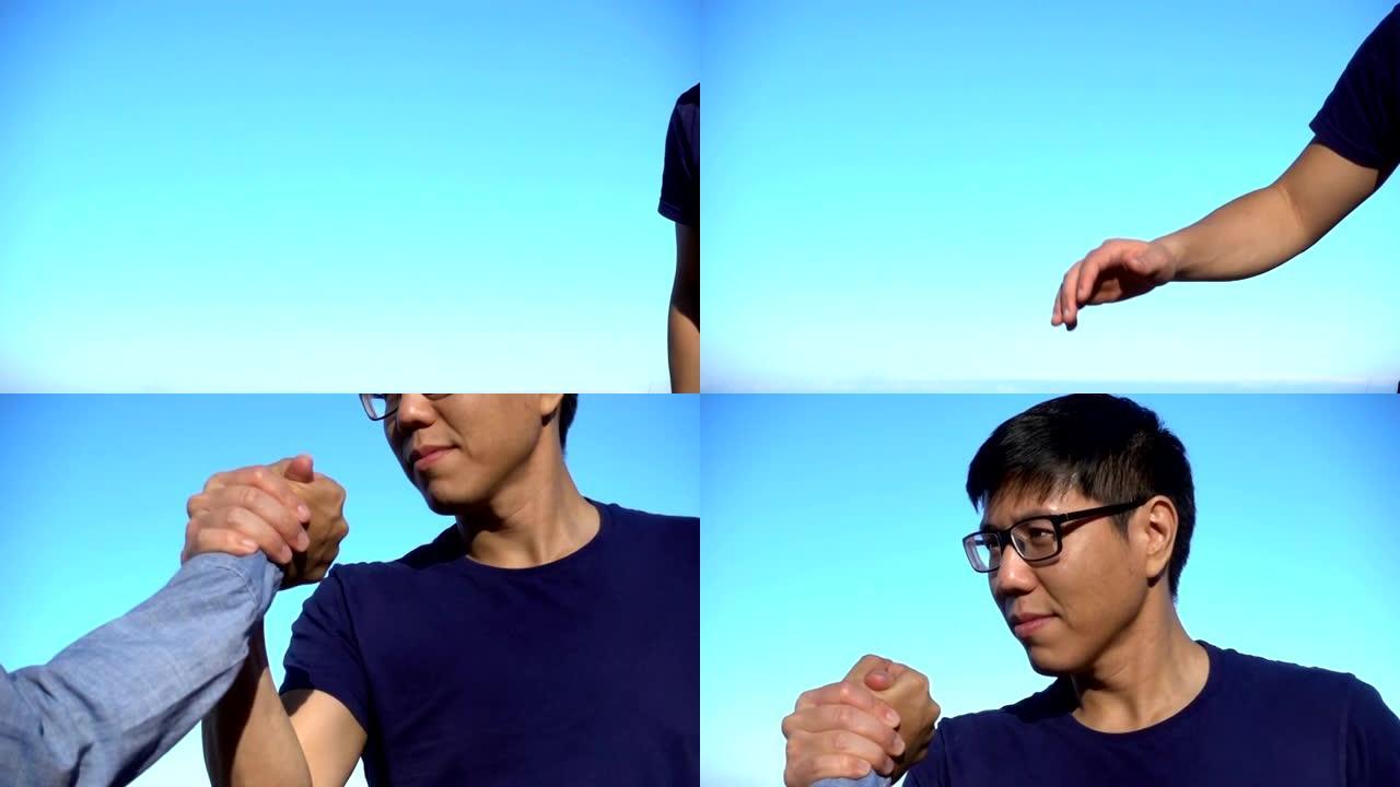 亚洲男子在山顶上进行运动握手的慢动作镜头