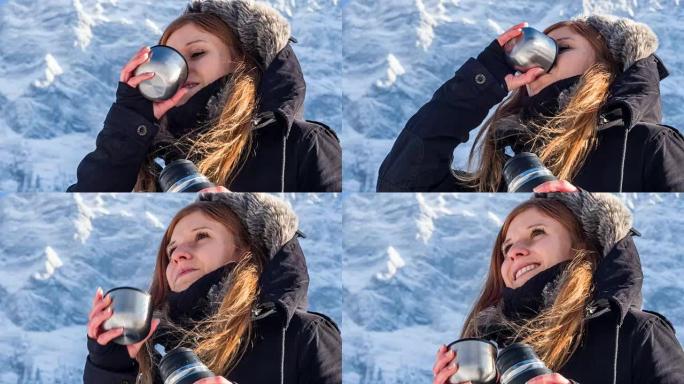 年轻女子用热水瓶喝水