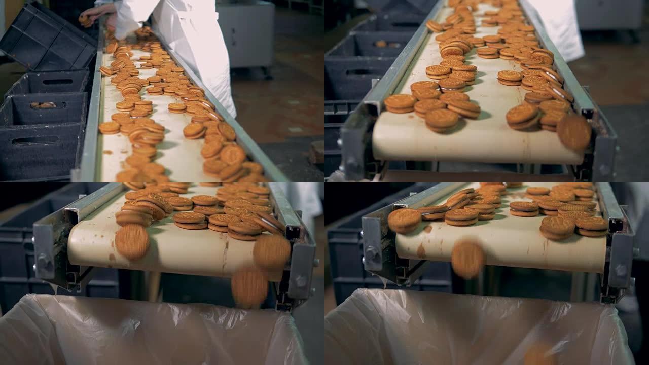 工人在生产线上分类甜饼干。食品厂生产线上的甜面包店。食品工厂的面包店生产。食品生产