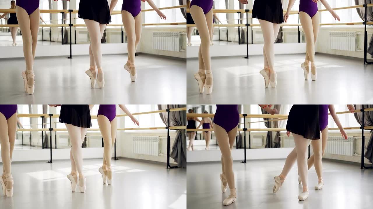 穿着芭蕾舞鞋的女性双腿低射，然后在light studio的地板上tip起脚尖跳舞。编舞、古典芭蕾、