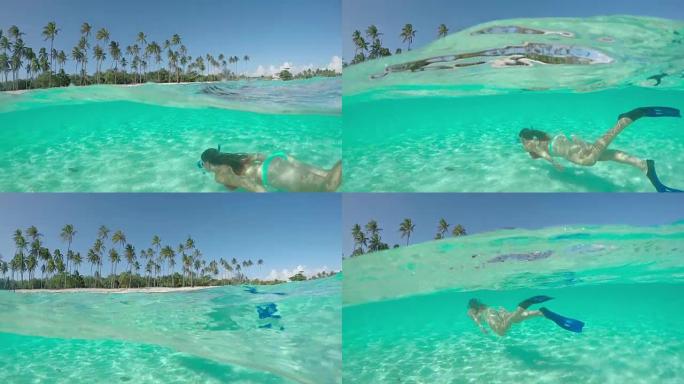 4k慢动作半水下特写: 快乐的年轻女子暑假在天堂游泳图片完美的绿松石蓝色泻湖走向热带岛屿