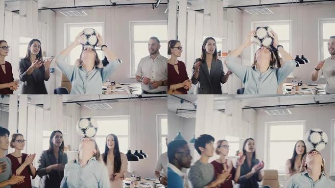 白人女孩在办公室正面玩足球。快乐的多种族商人庆祝工作成功鼓掌4K