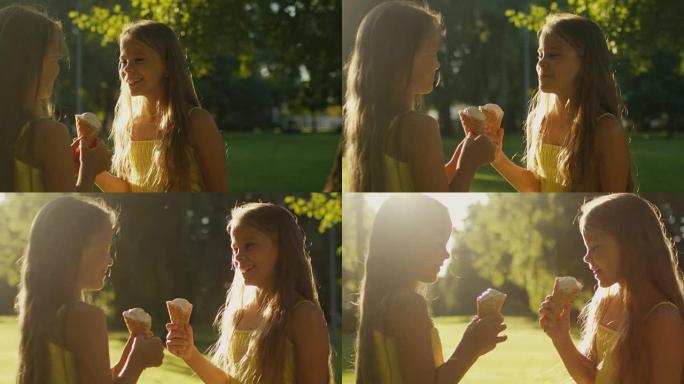 双胞胎女孩正在公园吃冰淇淋