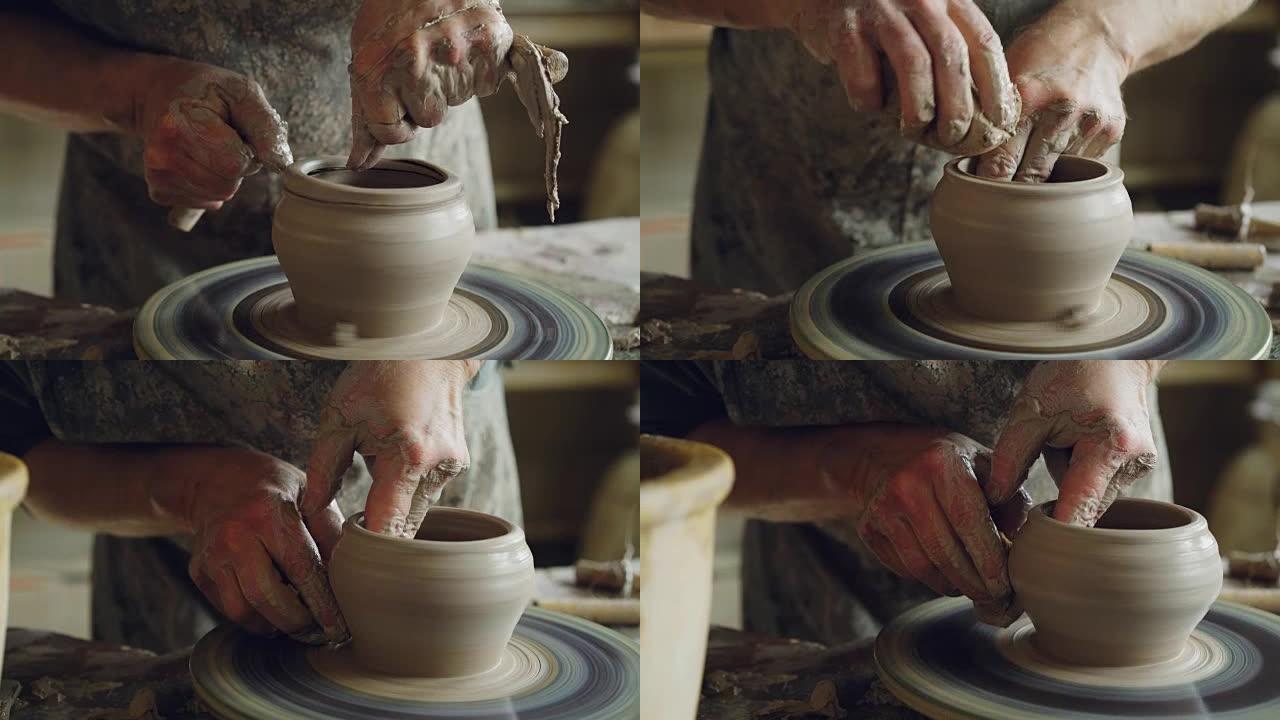 用专业工具在投掷轮上旋转半成品陶瓷锅和手切割粘土的特写镜头。创造了eathenware和传统陶器概念