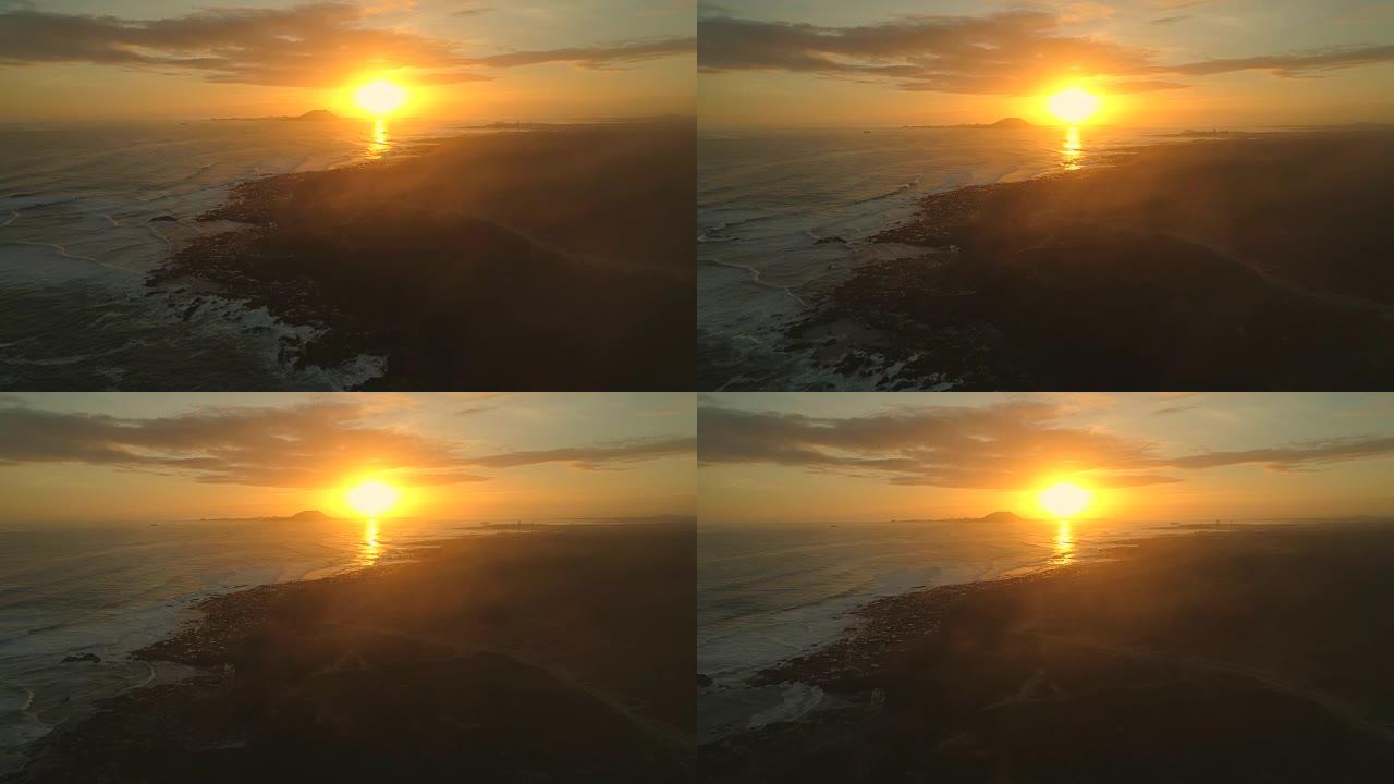 空中: 滚滚的泡沫波浪和富埃特文图拉岛上令人惊叹的金色日落
