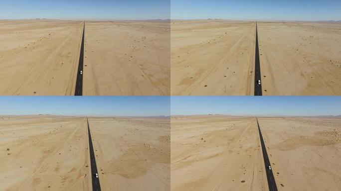 汽车在直道柏油上行驶穿过纳米布沙漠的4k鸟瞰图