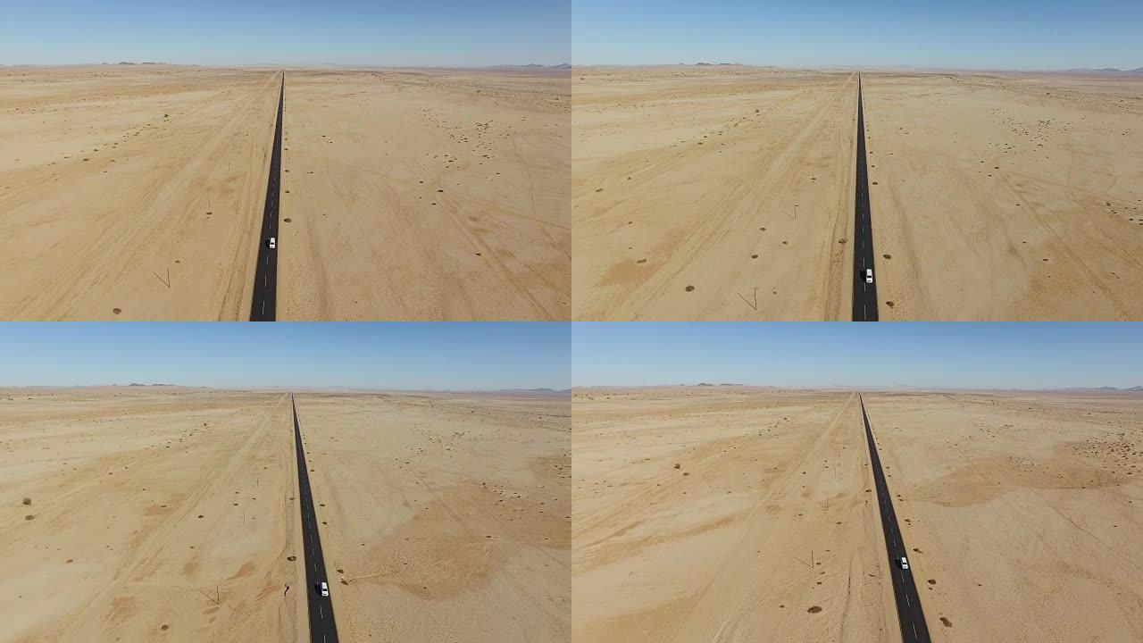 汽车在直道柏油上行驶穿过纳米布沙漠的4k鸟瞰图