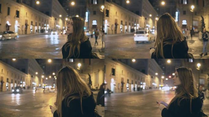年轻漂亮的女人晚上站在交通路附近，环顾四周，在智能手机中找到路