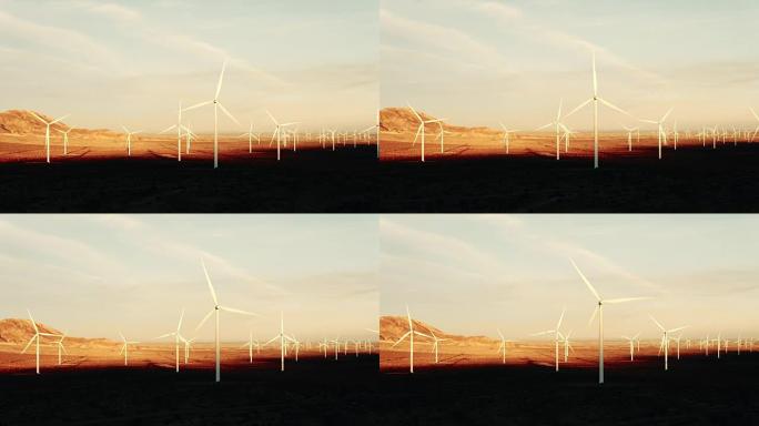 在沙漠中日落时旋转的风力涡轮机的空中轮廓