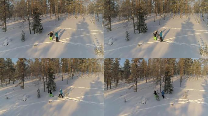 空中年轻人在阳光明媚的早晨穿着雪鞋探索白雪皑皑的拉普兰森林