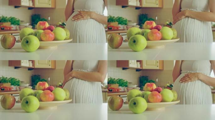 怀孕的苹果。孕妇吃健康午餐