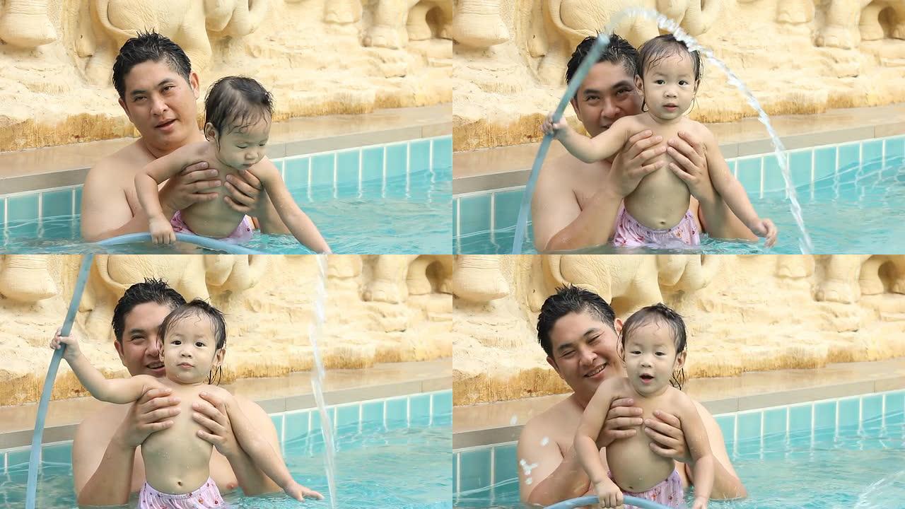 父亲和女儿在游泳池里。