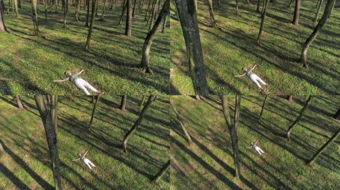 头上戴着花圈的空中女人躺在森林里