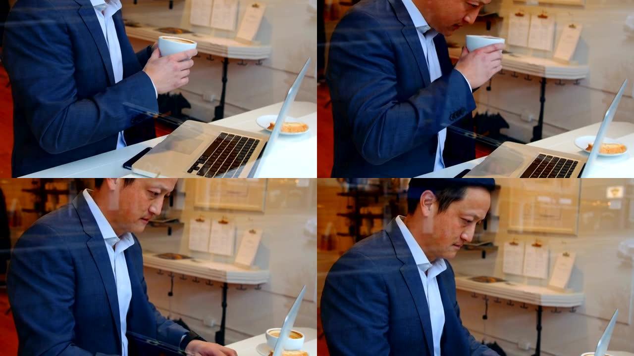 商人在喝咖啡时使用笔记本电脑