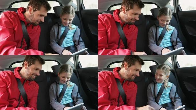 微笑的父女使用平板电脑坐在车内4K 4k
