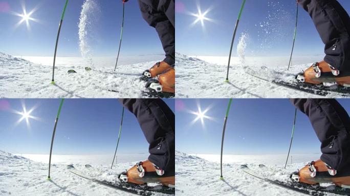 慢动作鱼眼: 滑雪者在晴天从滑雪板上清除新鲜的积雪