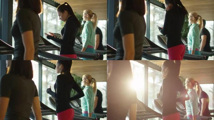 迷人的高加索女孩在运动健身房用耳机在跑步机上跑步。