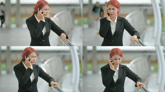 愤怒的亚洲女商人智能手机打字通话购物自拍