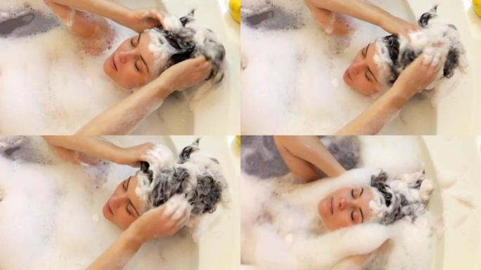 女人在泡泡浴中洗头的俯视图