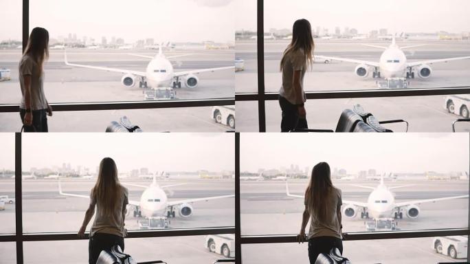 面目全非的女性旅行者带着包走到机场候机室候机楼的窗户，欣赏飞机的景色