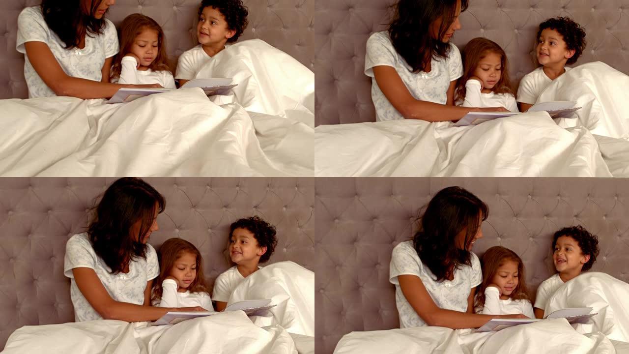 微笑的西班牙裔母亲和她的孩子躺在床上